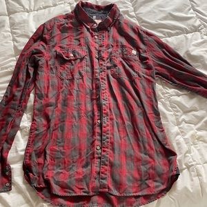 Medium red flannel shirt. Depart west